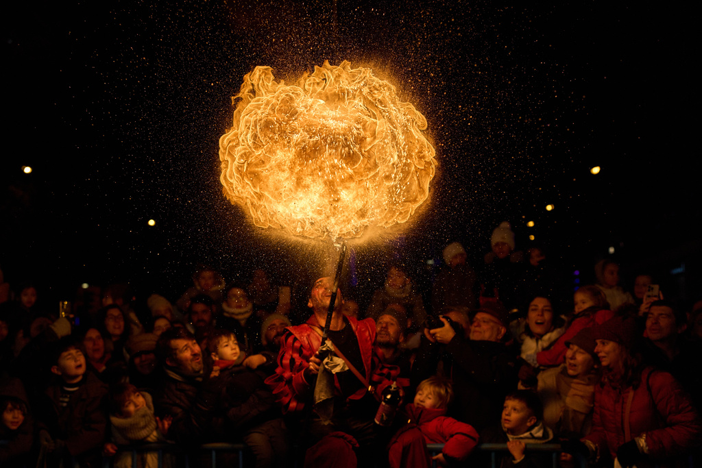 A fire eater performs during the traditional "Cabalgata de Reyes" parade in Madrid, Spain, Monday, Jan. 5, 2026, as part of the festivities marking the Catholic feast of Epiphany. (AP Photo/Bernat Armangue)