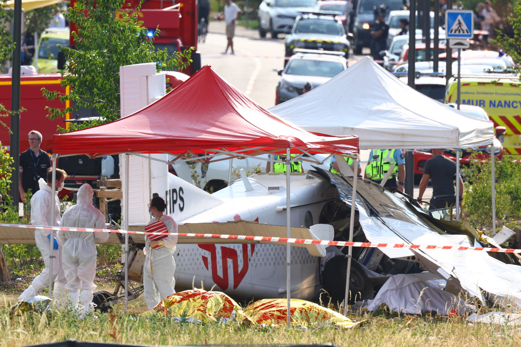 Forensic technicians examine a skydiving plane that crashed in Tomblaine northeastern France, killing all 11 people on board, Sunday, June 28, 2026. (AP Photo/Antonin Utz)