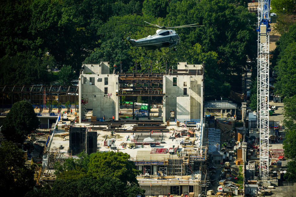 Marine One with President Donald Trump passes over construction on the new White House ballroom, Friday, Aug. 21, 2026, seen from the Washington Monument in Washington. (AP Photo/Julia Demaree Nikhinson)
