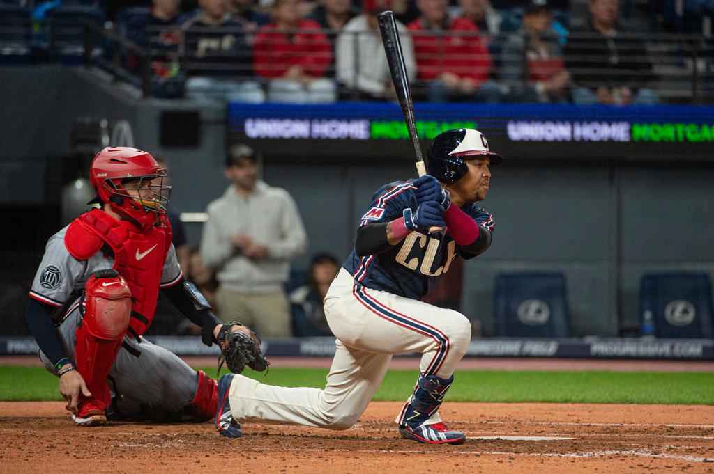 Cleveland Guardians' Jose Ramirez watches his single off Minnesota Twins starting pitcher Joe Ryan as Victor Caratini looks on during the fourth inning of a baseball game, Saturday, May 9, 2026, in Cleveland. (AP Photo/Phil Long)