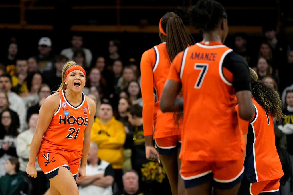 Virginia guard Kymora Johnson (21) celebrates after making a three-point basket during the first half against Iowa in the second round of the NCAA college basketball tournament, Monday, March 23, 2026, in Iowa City, Iowa. (AP Photo/Charlie Neibergall)