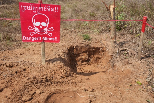 FILE - A "Danger Mines" sign marks an area as Cambodia Mine Action Center, CMAC, staff members work at a minefield in Preytotoeung village, Battambang province, Cambodia, Thursday, Jan. 19, 2023. (AP Photo/Heng Sinith, File) FILE - A "Danger Mines" sign marks an area as Cambodia Mine Action Center, CMAC, staff members work at a minefield in Preytotoeung village, Battambang province, Cambodia, Thursday, Jan. 19, 2023. (AP Photo/Heng Sinith, File)