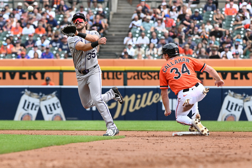 Colorado Rockies second baseman Connor Norby, left, throws to first base to complete the double play as Detroit Tigers' Brett Callahan is out at second base during the second inning of a baseball game, Saturday, Sept. 12, 2026, in Detroit. (AP Photo/Jose Juarez)