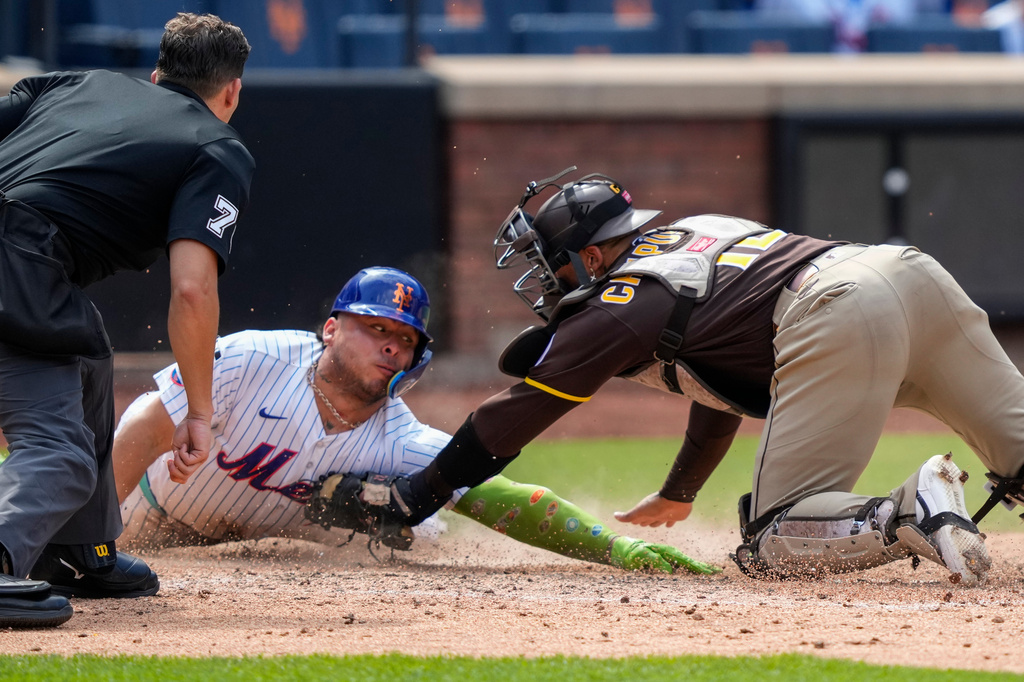 New York Mets designated hitter Francisco Alvarez is tagged out by San Diego Padres catcher Luis Campusano at home base during the seventh inning of a baseball game, Wednesday, Aug. 19, 2026, in New York. (AP Photo/Yuki Iwamura)