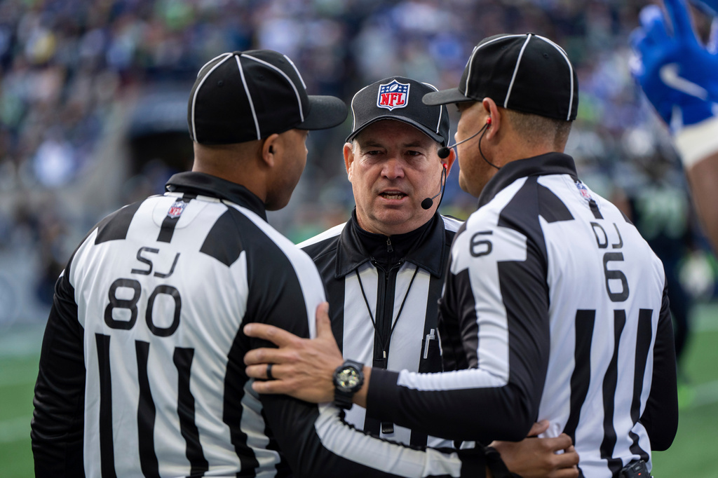 FILE - Field judge Alonzo Ramsey, left, back judge Greg Wilson and down judge Jerod Phillips confer during an NFL football game against the Seattle Seahawks, Sunday, Nov. 3, 2024, in Seattle. (AP Photo/Stephen Brashear, File)