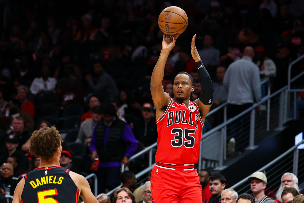Chicago Bulls forward Isaac Okoro (35) looks to shoot over Atlanta Hawks guard Dyson Daniels, left, during the first half of an NBA basketball game, Sunday, Dec. 21, 2025, in Atlanta. (AP Photo/Colin Hubbard)