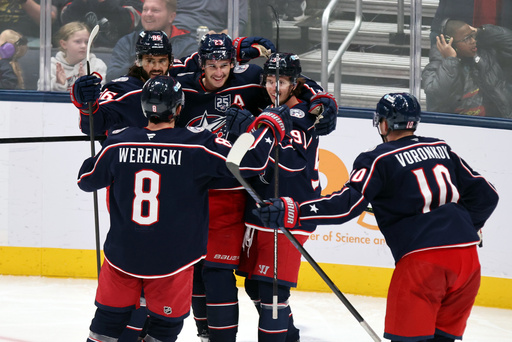 Columbus Blue Jackets defenseman Sean Monahan (23) celebrates his goal against the St. Louis Blues with teammates defenseman Zach Werenski (8), forward Kirill Marchenko (86), forward Kent Johnson (91), forward Dmitri Voronkov (10) during the third period of an NHL hockey game in Columbus, Ohio, Saturday, Nov. 1, 2025. (AP Photo/Paul Vernon) Columbus Blue Jackets defenseman Sean Monahan (23) celebrates his goal against the St. Louis Blues with teammates defenseman Zach Werenski (8), forward Kirill Marchenko (86), forward Kent Johnson (91), forward Dmitri Voronkov (10) during the third period of an NHL hockey game in Columbus, Ohio, Saturday, Nov. 1, 2025. (AP Photo/Paul Vernon)
