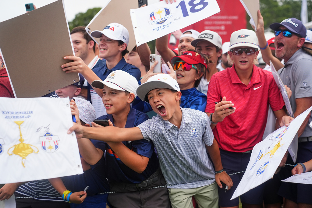 Fans try for autographs during a practice round for the Ryder Cup golf tournament, Wednesday, Sept. 24, 2025, on the Bethpage Black golf course, in Farmingdale, N.Y. (AP Photo/Lindsey Wasson)
