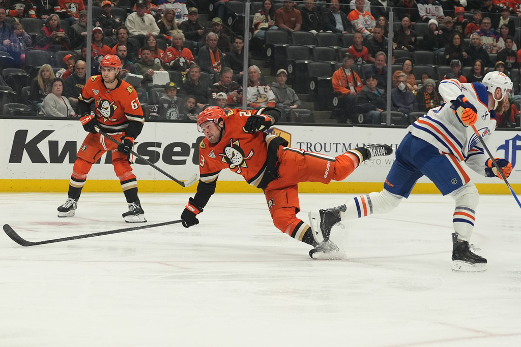 Anaheim Ducks center Mason McTavish, left, falls after colliding with Edmonton Oilers defenseman Mattias Ekholm, right, during the first period of an NHL hockey game Wednesday, Feb. 25, 2026, in Anaheim, Calif. (AP Photo/Gregory Bull)