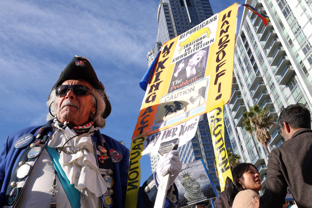 Protesters gather during a demonstration calling for an end to federal immigration enforcement operations and U.S. attacks on Venezuela, Saturday, Jan. 10, 2026, in Los Angeles. (AP Photo/Jill Connelly)