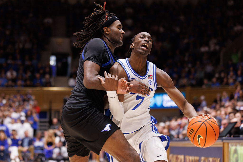 Duke's Dame Sarr (7) is fouled by SMU's Jaden Toombs, left, during the second half of an NCAA college basketball game in Durham, N.C., Saturday, Jan. 10, 2026. (AP Photo/Ben McKeown)