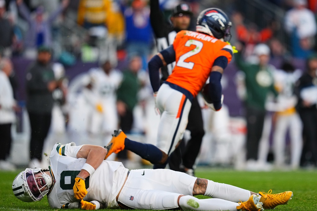 Green Bay Packers' Christian Watson is hurt after Denver Broncos' Pat Surtain II intercepts a pass during the second half of an NFL football game Sunday, Dec. 14, 2025, in Denver. (AP Photo/Jack Dempsey)