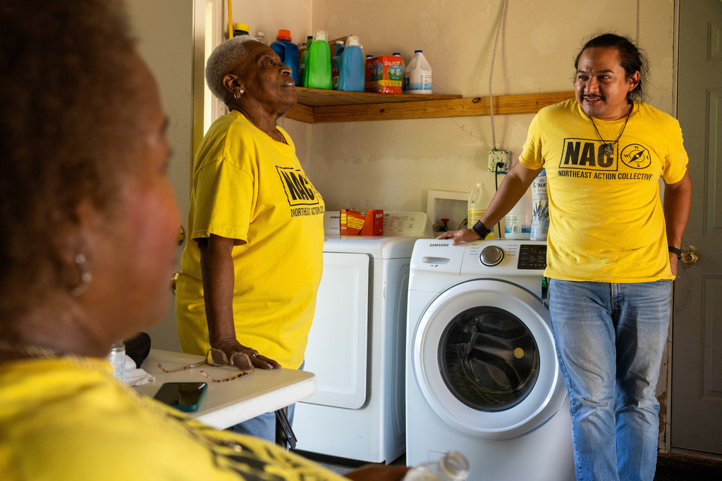 From left, Leola Cornett-Traeye, Doris Brown, Hub home captain, and David Espinoza, Hub home captain and co-director of community organizing at West Street Recovery, talk inside Brown's hub home, Wednesday, Oct. 8, 2025, in Houston. (AP Photo/Antranik Tavitian)