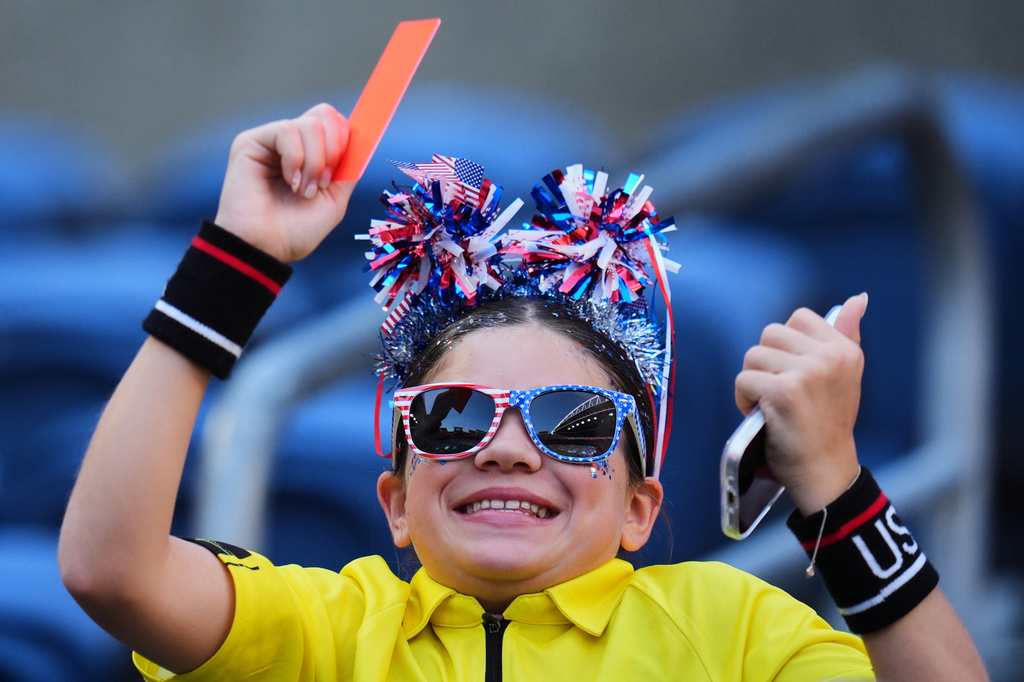 A fan of the United States holds a red card as they wait for the beginning of the World Cup round of 16 soccer match between the United States and Belgium in Seattle, Monday, July 6, 2026. (AP Photo/Manu Fernandez)