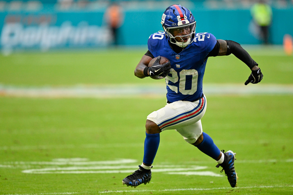 New York Giants running back Eric Gray (20) runs the ball during the second half of a preseason NFL football game against the Miami Dolphins, Saturday, Aug. 22, 2026, in Miami Gardens, Fla. (AP Photo/Doug Murray)