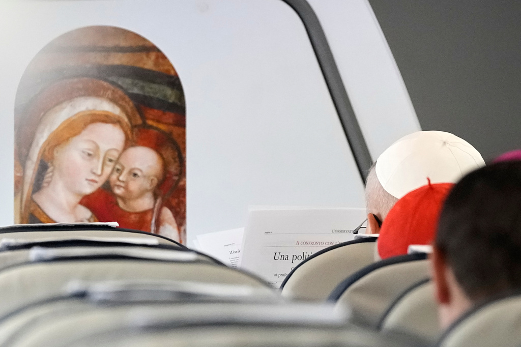 Pope Leo XIV reads L'Osservatore Romano newspaper aboard an ITA Airways Airbus A320neo during his flight from Rome to Madrid, Saturday, June 6, 2026, marking the start of a seven-day apostolic journey to mainland Spain and the Canary Islands. (AP Photo/Alessandra Tarantino, Pool)