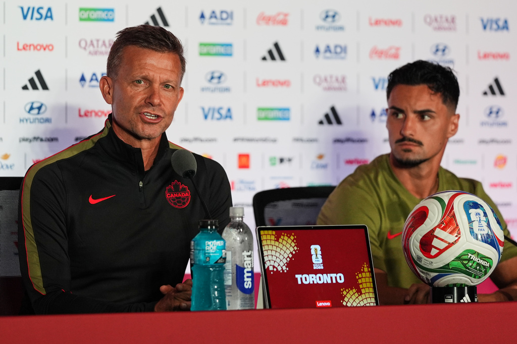 Canada head coach Jesse Marsch, left, with Stephen Eustaquio, speaks during a press conference, Thursday, June 11, 2026, in Toronto, on the eve of the team's World Cup soccer match against Bosnia. (AP Photo/Stephanie Scarbrough)