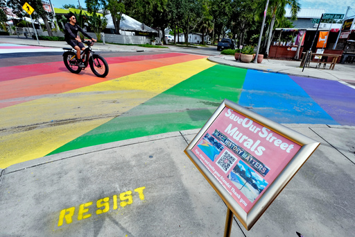 FILE - A cyclist crosses a rainbow-painted intersection, Aug. 27, 2025, in St. Petersburg, Fla. (AP Photo/Chris O'Meara, file) FILE - A cyclist crosses a rainbow-painted intersection, Aug. 27, 2025, in St. Petersburg, Fla. (AP Photo/Chris O'Meara, file)