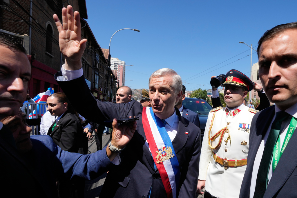 Chile's President Jose Antonio Kast waves to supporters as he leaves Congress after his swearing-in ceremony in Valparaiso, Chile, Wednesday, March 11, 2026. (AP Photo/Gustavo Garello)