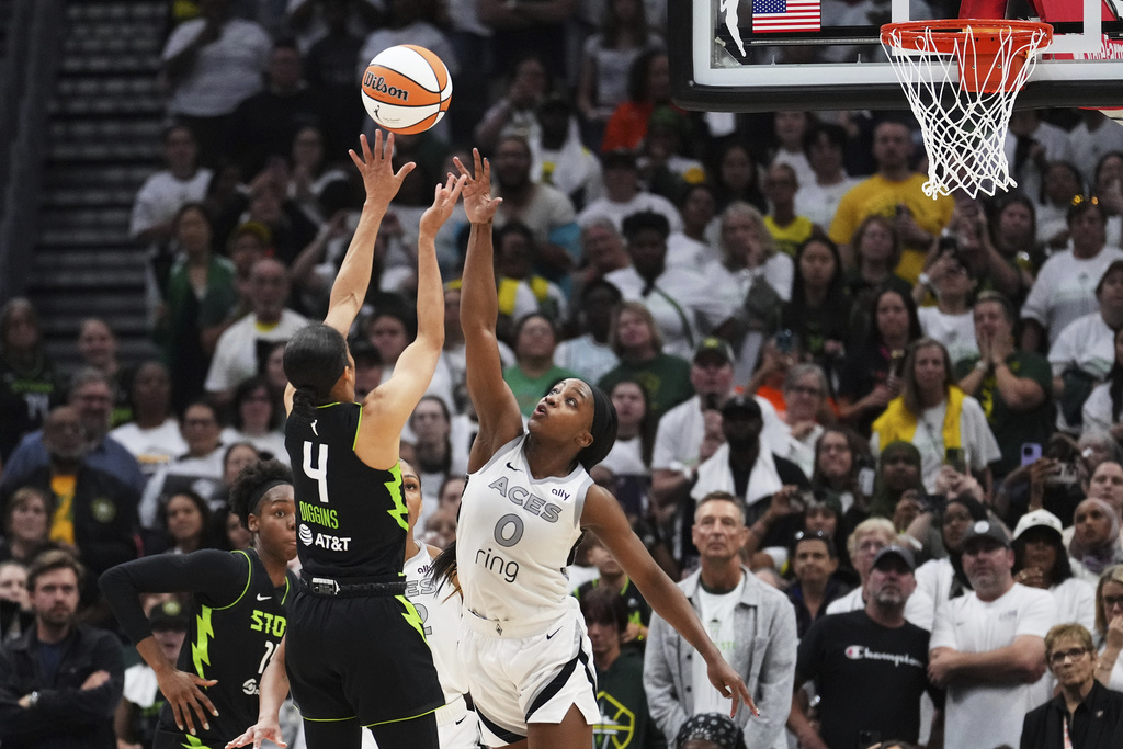 Seattle Storm guard Skylar Diggins (4) makes a shot over Las Vegas Aces guard Jackie Young (0) to give the Storm the lead during the second half of Game 2 in the first round of the WNBA basketball playoffs Tuesday, Sept. 16, 2025, in Seattle. (AP Photo/Lindsey Wasson)