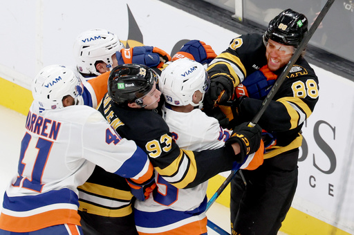 Boston Bruins center Fraser Minten (93) and Boston Bruins right wing David Pastrnak (88) get into a fight with New York Islanders including defenseman Marshall Warren (41) during the third period of an NHL hockey game, Tuesday, Oct. 28, 2025, in Boston. (AP Photo/Mark Stockwell) Boston Bruins center Fraser Minten (93) and Boston Bruins right wing David Pastrnak (88) get into a fight with New York Islanders including defenseman Marshall Warren (41) during the third period of an NHL hockey game, Tuesday, Oct. 28, 2025, in Boston. (AP Photo/Mark Stockwell)