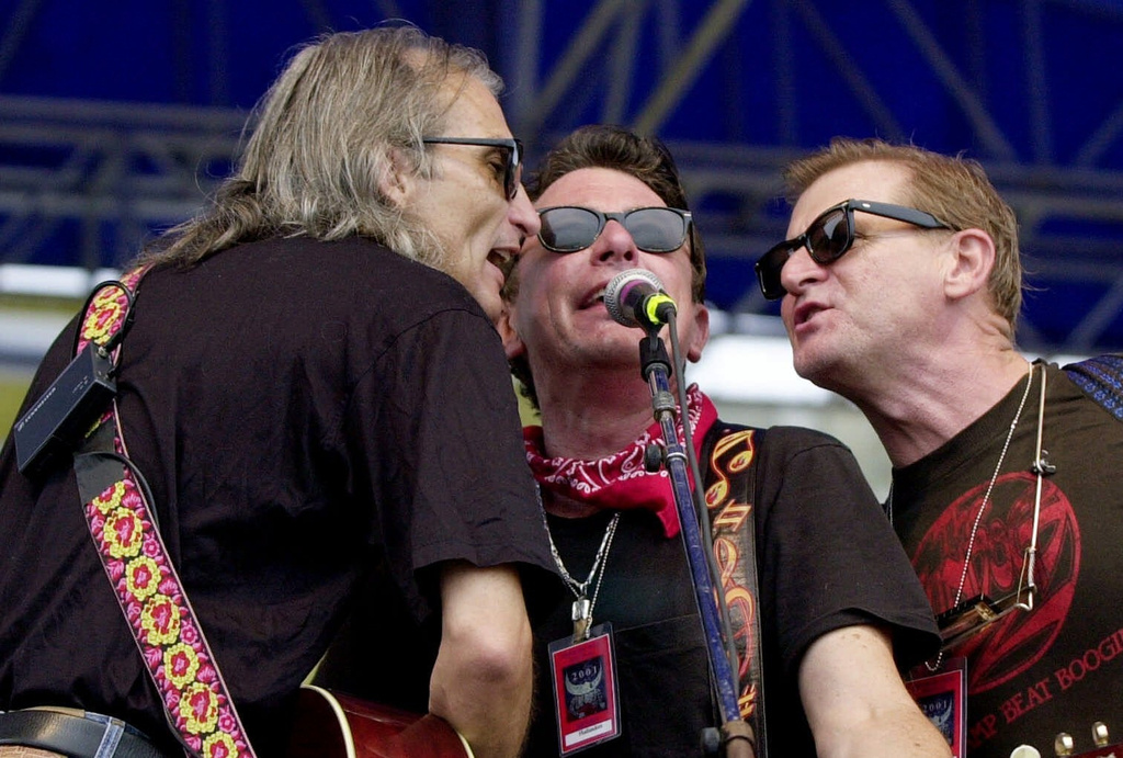 FILE - Jimmie Dale Gilmore, left, Joe Ely and Butch Hancock, right, from the band The Flatlanders perform at the Newport Folk Festival on the Fort Adams stage in Newport, R.I., Saturday, Aug. 4, 2001. (AP Photo/Edward Stapel, file)