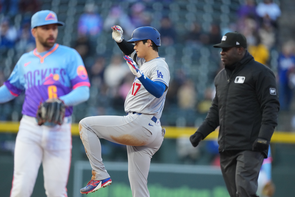 Los Angeles Dodgers' Shohei Ohtani celebrates after reaching second base with a double off Colorado Rockies starting pitcher Tomoyuki Sugano in the first inning of a baseball game Friday, April 17, 2026, in Denver. (AP Photo/David Zalubowski)