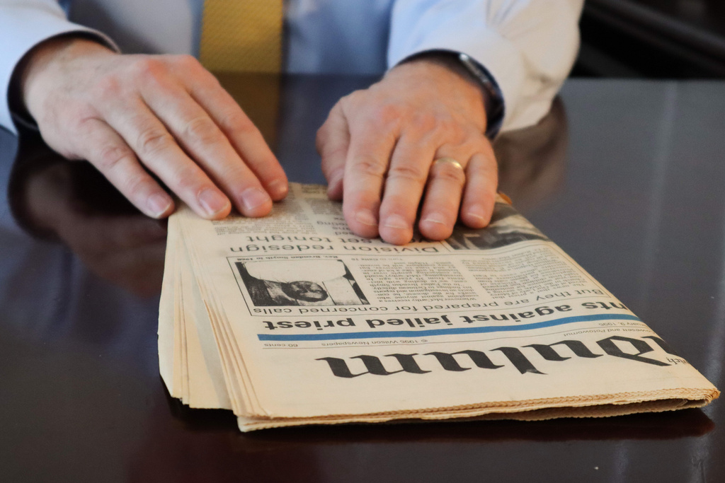 Dr. Herbert "Hub" Brennan, a clergy abuse survivor, shows at a 1995 newspaper article about the arrest of the Rev. Brendan Smyth while at his internal medicine office in East Greenwich, R.I., Thursday, March 5, 2026. (AP Photo/Leah Willingham)