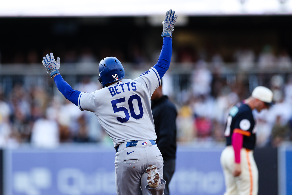 Los Angeles Dodgers' Mookie Betts celebrates as he runs the bases after hitting a solo home run against the San Diego Padres in the first inning of a baseball game, Friday, June 26, 2026, in San Diego. (AP Photo/Derrick Tuskan)