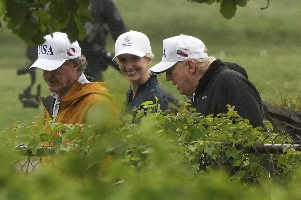 President Donald Trump, from right, White House aide Natalie Harp and Interior Secretary Doug Burgum walk during a tour of the East Potomac Park golf course, Sunday, June 28, 2026, in Washington. (AP Photo/Mark Schiefelbein)