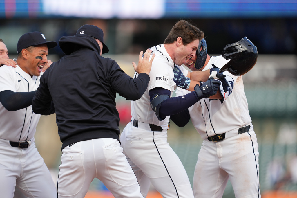 Detroit Tigers second baseman Colt Keith, right, celebrates his one-run single against the Kansas City Royals during the ninth inning of a baseball game Thursday, April 16, 2026, in Detroit. (AP Photo/Paul Sancya)