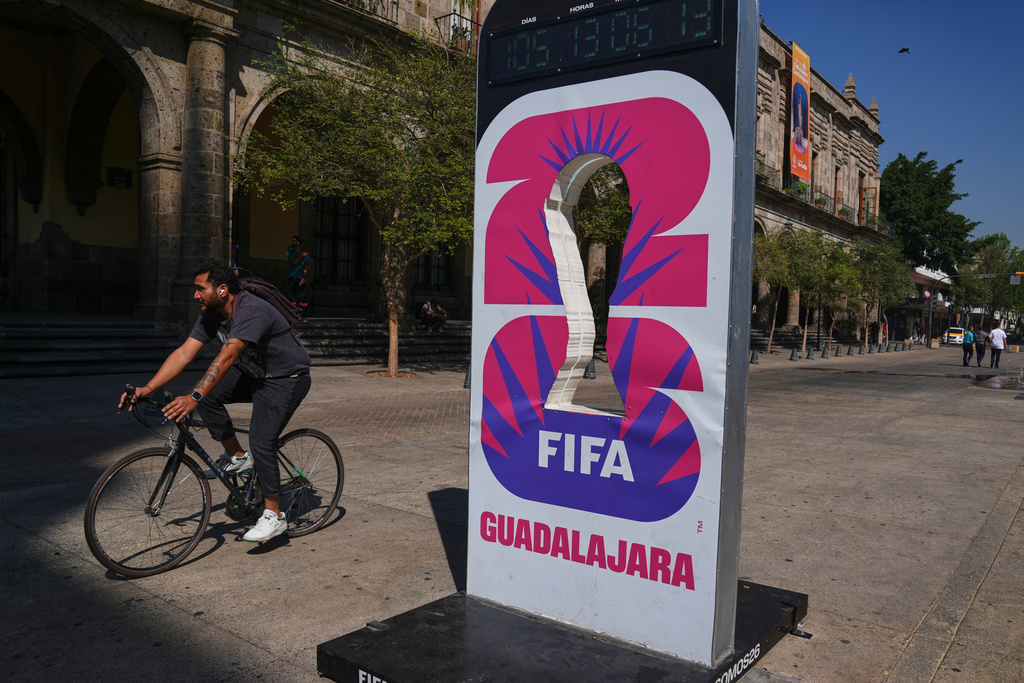 A cyclist rides past an installation promoting the FIFA World Cup 2026 in Guadalajara, Mexico, Wednesday, Feb. 25, 2026. (AP Photo/Marco Ugarte)
