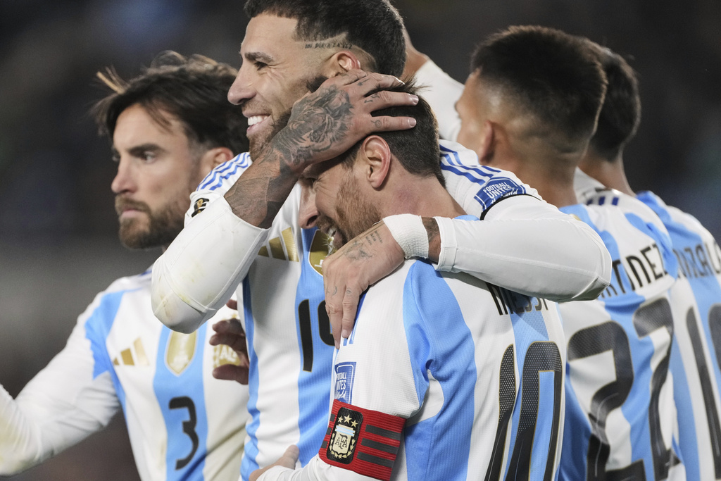 Argentina's Nicolas Otamendi congratulates Lionel Messi after he scored his side's third goal against Venezuela during a World Cup 2026 qualifying soccer match at the Monumental stadium in Buenos Aires, Argentina, Thursday, Sept. 4, 2025. (AP Photo/Gustavo Garello)