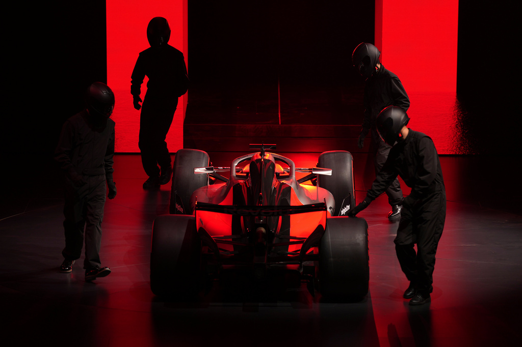 Workers push out a Audi R26 racing car during the Volkswagen Group Media Night event ahead of the Auto China 2026 show to be held in Beijing, Tuesday, April 21, 2026. (AP Photo/Ng Han Guan)