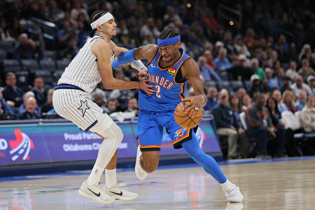 Oklahoma City Thunder guard Shai Gilgeous-Alexander (2) drives against Orlando Magic guard Anthony Black, left, during the second half of an NBA basketball game Tuesday, Feb. 3, 2026, in Oklahoma City. (AP Photo/Nate Billings)