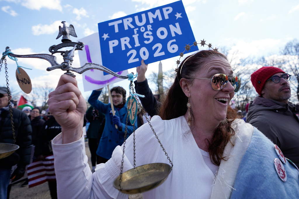 Demonstrators rally near the Washington Monument during the No Kings protest in Washington, Saturday, March 28, 2026. (AP Photo/Jose Luis Magana)