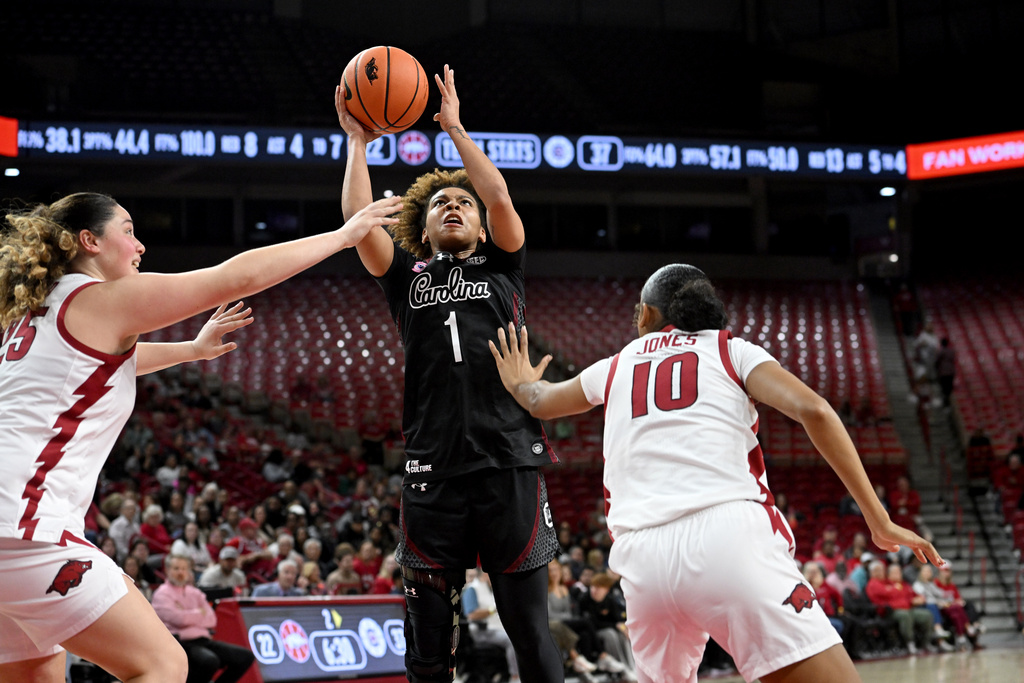 South Carolina guard Maddy McDaniel (1) shoots over Arkansas defenders Danika Galea (25) and Taleyah Jones (10) during the first half of an NCAA college basketball game Thursday, Jan. 8, 2026, in Fayetteville, Ark. (AP Photo/Michael Woods)