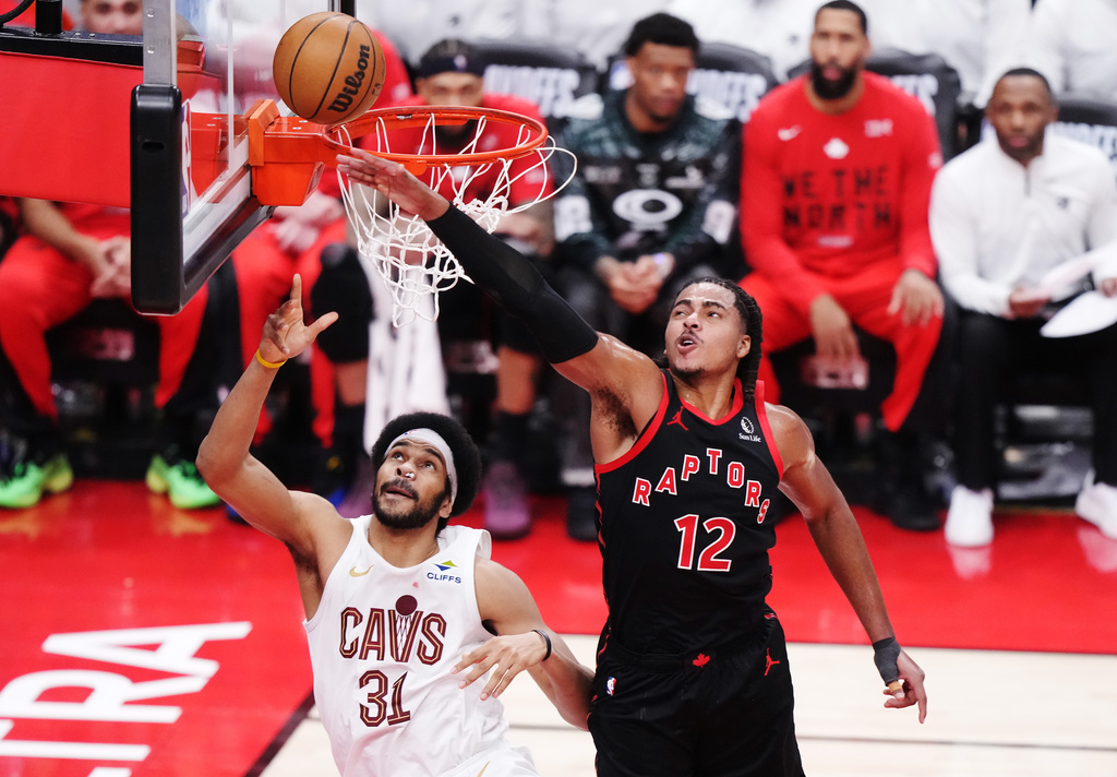 Cleveland Cavaliers' Jarrett Allen (31) scores as Toronto Raptors' Collin Murray-Boyles (12) defends during the first half of an NBA basketball playoff game in Toronto on Thursday, April 23, 2026. (Nathan Denette/The Canadian Press via AP)