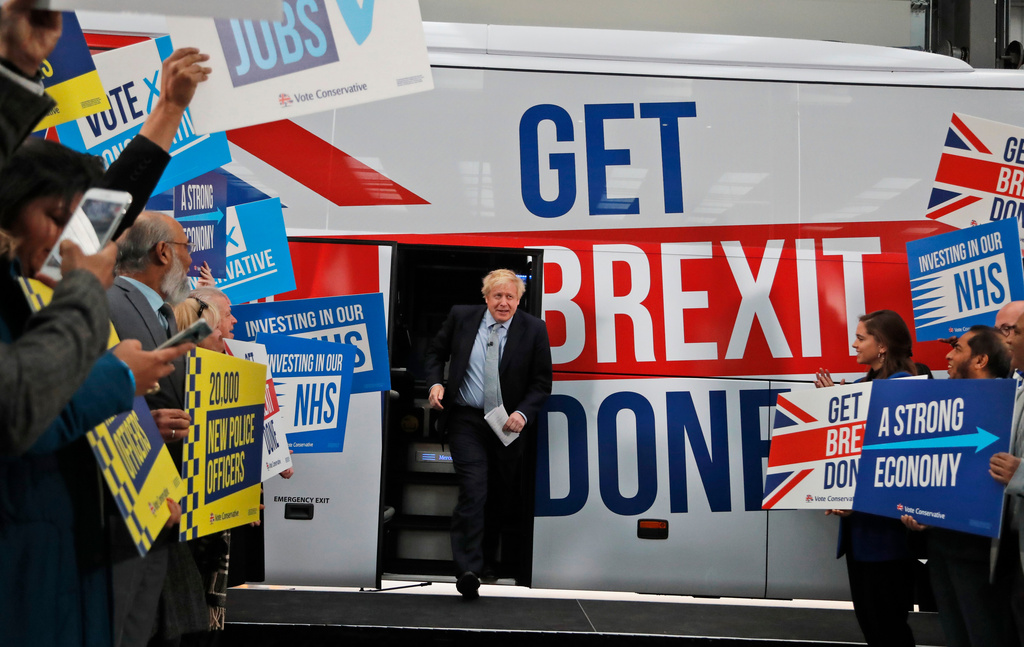 FILE - Britain's Prime Minister Boris Johnson addresses his supporters prior to boarding his General Election campaign trail bus in Manchester, England, Friday, Nov. 15, 2019. (AP Photo/Frank Augstein, Pool, File)
