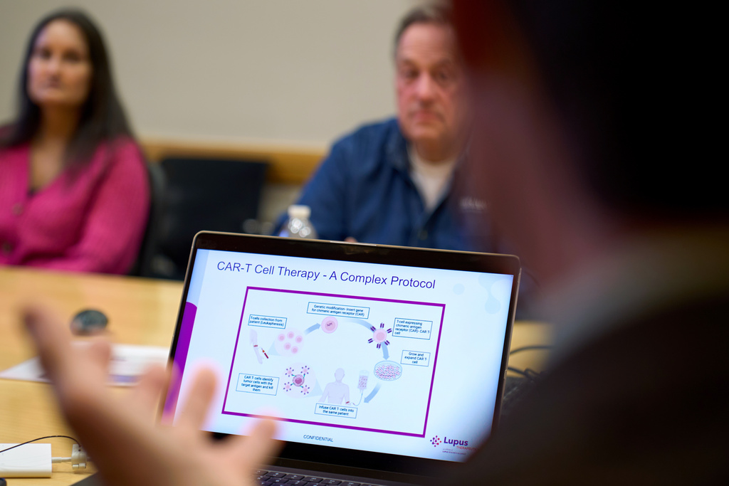 A graphic explaining CAR-T cell therapy is displayed on the laptop of Dr. Roberto Caricchio, director of the Lupus Center at UMass Chan Medical School, as he speaks to a lupus support group at its campus, Wednesday, Feb. 12, 2025, in Worcester, Mass. (AP Photo/David Goldman)