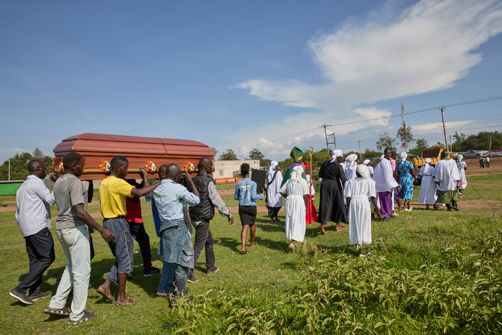 Mourners carry a coffin during a funeral procession led by a Christian congregation on the outskirts of Kisumu, Kenya, Friday, March 13, 2026. (AP Photo/Asa Wallin)