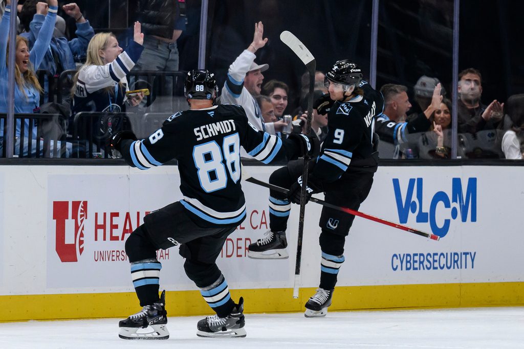 Utah Mammoth right wing Clayton Keller (9) and defenseman Nate Schmidt (88) celebrate after Keller's goal during the second period of an NHL hockey game against the Minnesota Wild, Friday, Feb. 27, 2026, in Salt Lake City. (AP Photo/Tyler Tate)