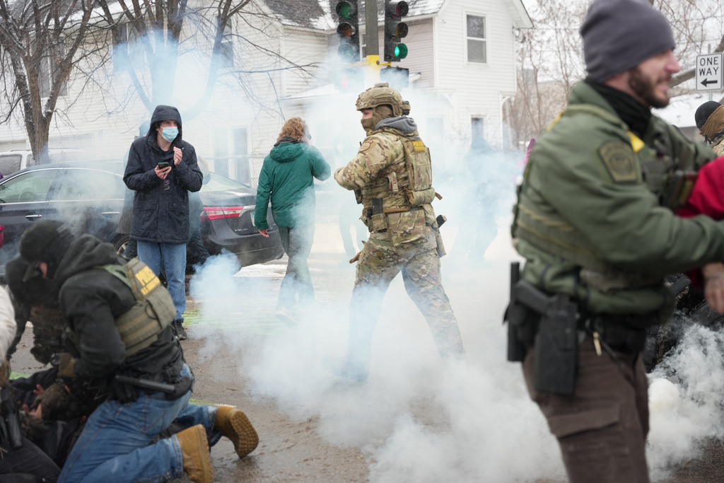 Tear gas is deployed as Federal agents make arrests on Wednesday, Jan. 21, 2026, in Minneapolis. (AP Photo/Angelina Katsanis)