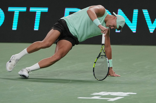 Holger Rune of Denmark stands up after suffering from leg cramps during the men's singles quarterfinals match against Valentin Vacherot of Monaco, at the Shanghai Masters tennis tournament at Qizhong Forest Sports City Tennis Center, in Shanghai, China, Thursday, Oct. 9, 2025. (AP Photo/Andy Wong) Holger Rune of Denmark stands up after suffering from leg cramps during the men's singles quarterfinals match against Valentin Vacherot of Monaco, at the Shanghai Masters tennis tournament at Qizhong Forest Sports City Tennis Center, in Shanghai, China, Thursday, Oct. 9, 2025. (AP Photo/Andy Wong)