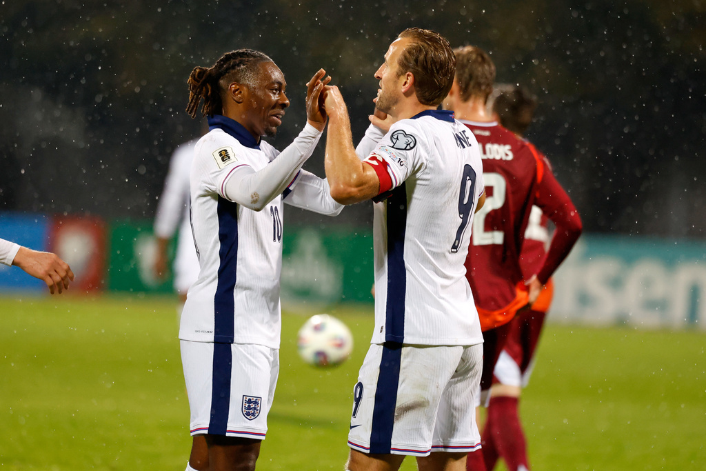 England's Eberechi Eze, left, celebrates with Harry Kane after scoring his side's fifth goal during the 2026 World Cup group K qualifying soccer match between Latvia and England in Riga, Latvia, Tuesday, Oct. 14, 2025. (AP Photo/Mindaugas Kulbis)