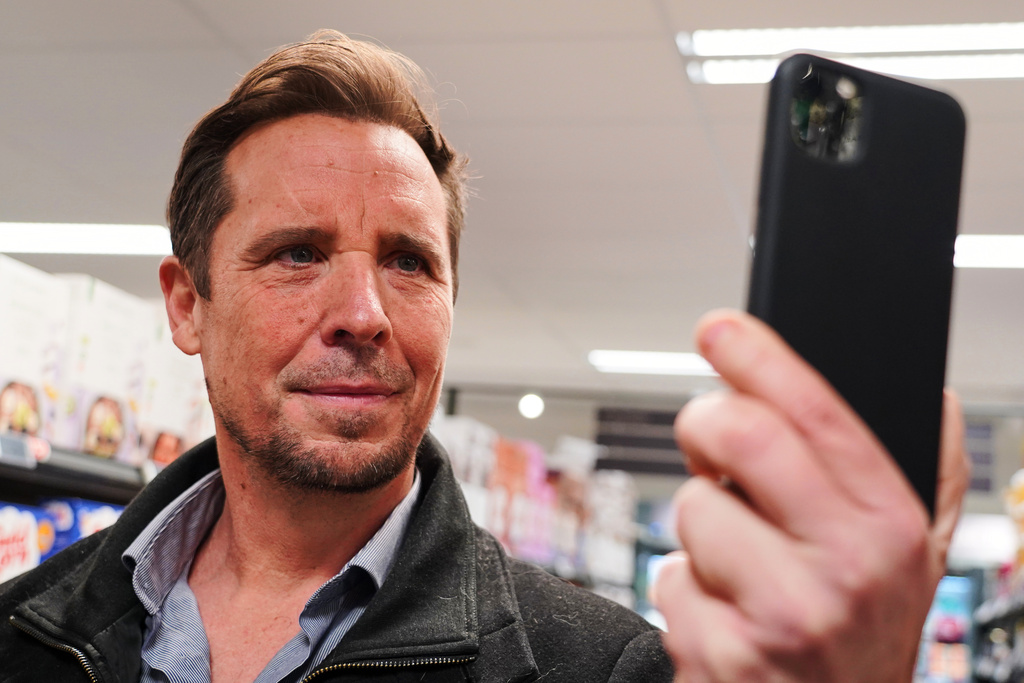 Ian Rosenfeldt, the creator of "Made O'Meter" mobile app, demonstrates how shoppers can use the application to identify and boycott American goods in a grocery store in Copenhagen, Wednesday, Jan. 28, 2026. (AP Photo/James Brooks)