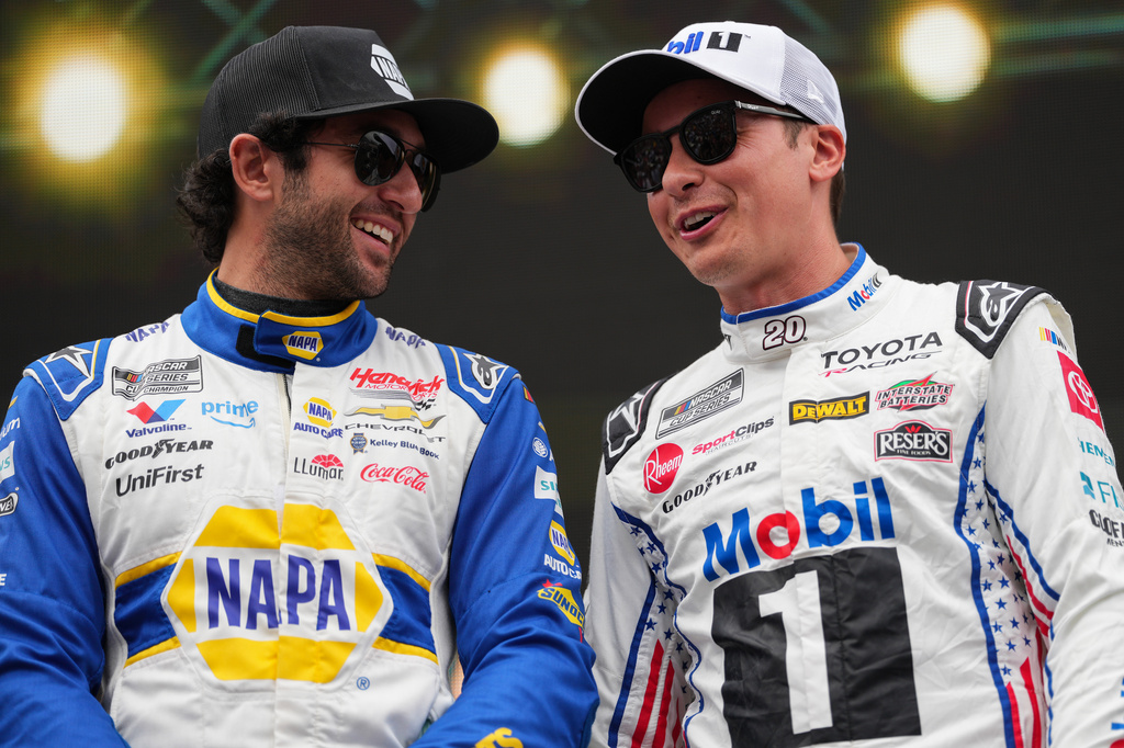 Chase Elliott, left, and Christopher Bell, right, interact prior to a NASCAR Cup Series auto race Sunday, Sept. 6, 2026, in Darlington, S.C. (AP Photo/Matt Kelley)