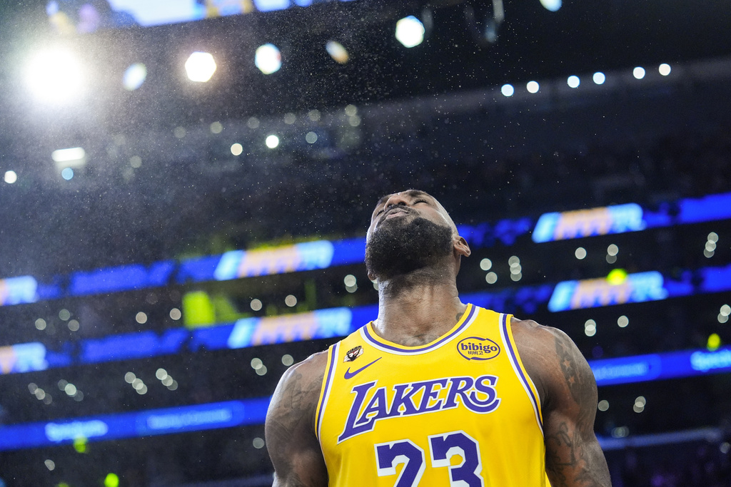 Los Angeles Lakers forward LeBron James (23) pauses after tossing power before an NBA basketball game against the Golden State Warriors Saturday, Feb. 7, 2026, in Los Angeles. (AP Photo/Jae C. Hong)