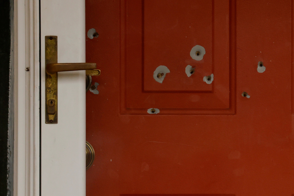 FILE - Bullet holes mark the front door of the house of Minnesota state Sen. John Hoffman and his wife who were shot earlier in the day on June 14, 2025, in Champlin, Minn. (AP Photo/Bruce Kluckhohn, File)