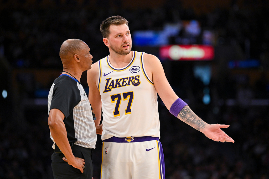 Los Angeles Lakers guard Luka Doncic speaks to referee Michael Smith during the first half of an NBA basketball game against the Boston Celtics, Sunday, Feb. 22, 2026, in Los Angeles. (AP Photo/Katie Chin)